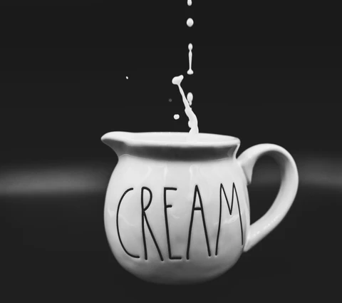 cream-dripping-into-ceramic-creamer_large